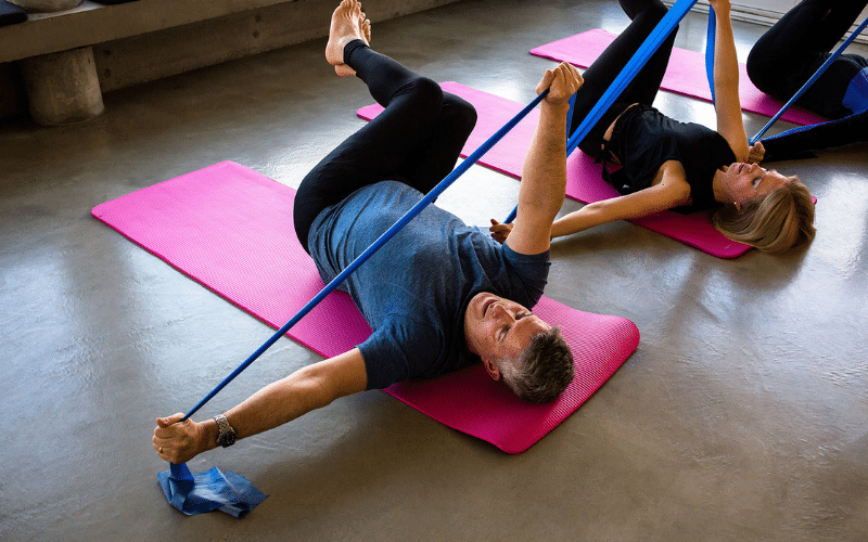 Pilates mat class demonstrating resistance exercises for bone density